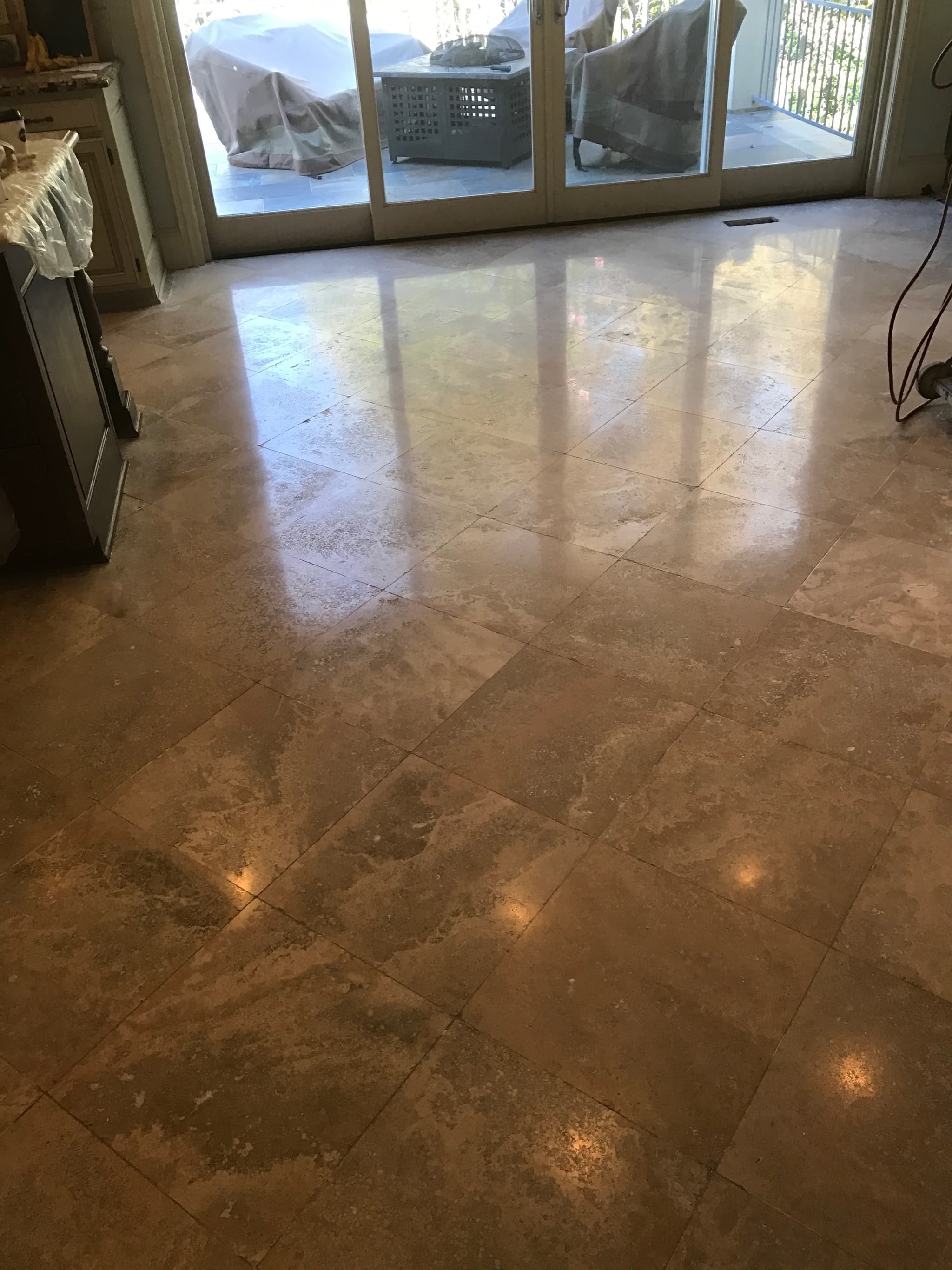 Marble polishing and floor repair showing mirror finish on Carrara marble