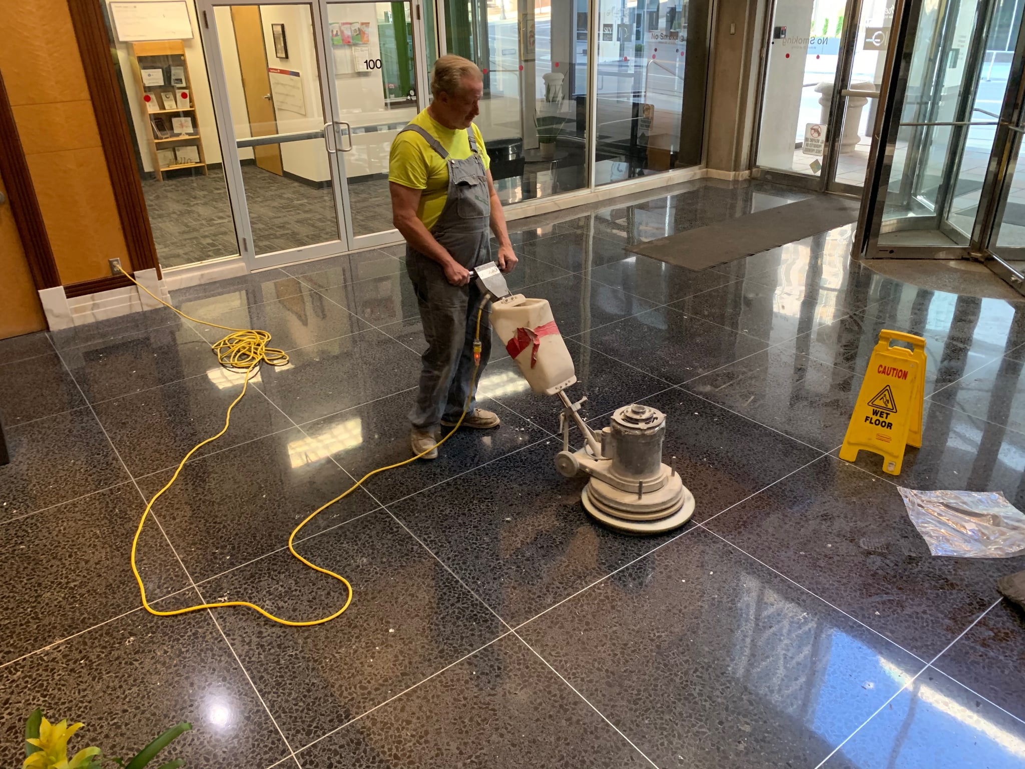 John Jackson operating professional stone restoration equipment on marble floor at commercial property in Kansas City